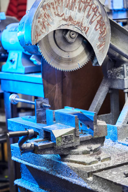 Cutting aluminium billet with machine.  "nCircular milling machine cutting metal profile."nSteel industry. stock photo