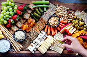 istock cutting board with gourmet food, fruits, vegetables and cheese 1370513135