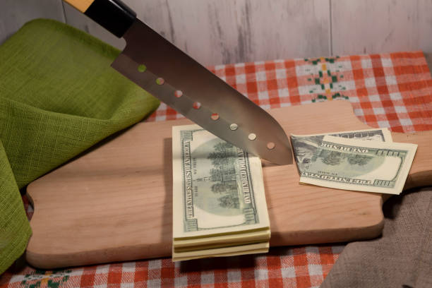 Newly Sharpened Knife Cutting Dollar Bill