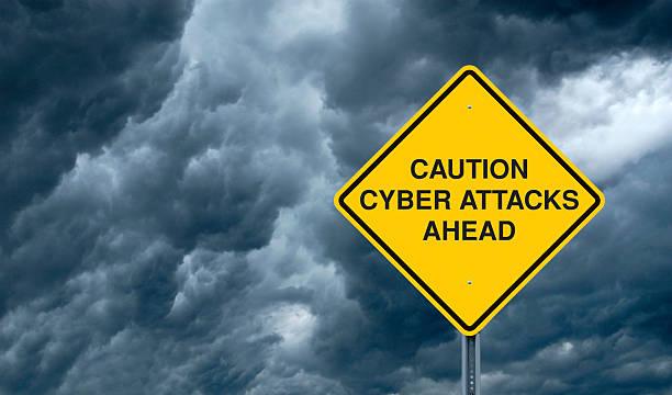 Cyber Attacks A Caution Sign in Front of Storm Clouds Warning of "Cyber Attacks Ahead." threats stock pictures, royalty-free photos & images