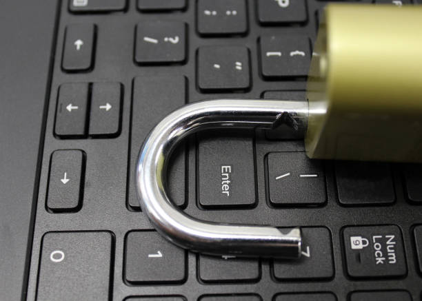 cyber security breach concept open lock on computer keyboard stock photo