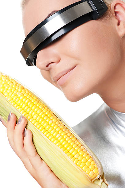 Cyber woman with a corn stock photo