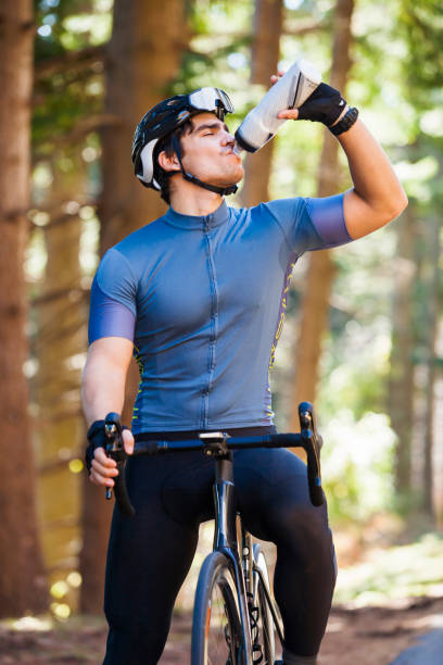 Cyclist drinking water during a riding break stock photo