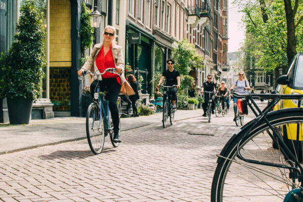 cyclist in amsterdam - amsterdam street imagens e fotografias de stock