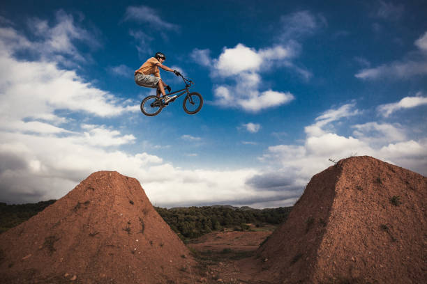 BMX cyclist jumping high. Real jump. stock photo