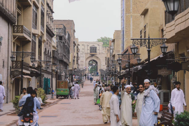 Daily life of the crowded Pakistan city center with the Buildings and Rickshaws stock photo