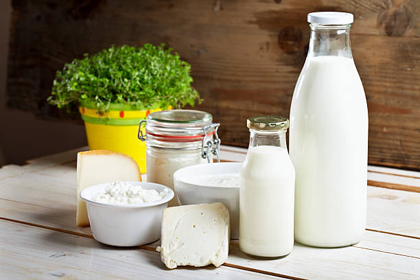dairy products cheese yoghurt milk dairy products such as cheese,yoghurt,cottage cheese, milk in a glass bottle  on wooden table cream dairy product stock pictures, royalty-free photos & images