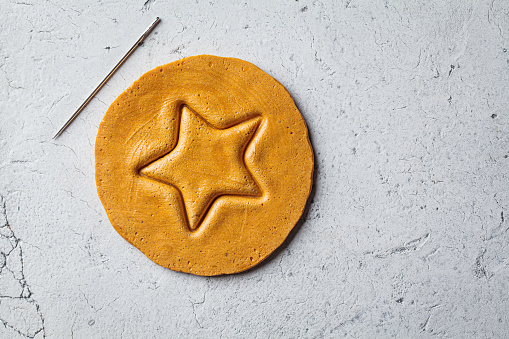 Dalgona Candy - South Korean treat. Round sugar cookie with a star inside, top view.