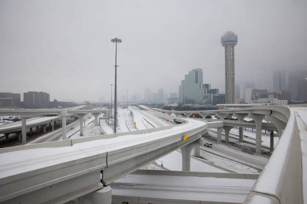 Dallas Winter Storm 2021 Pedestrians walk snowy streets in downtown streets during rush hour in downtown Dallas storm stock pictures, royalty-free photos & images