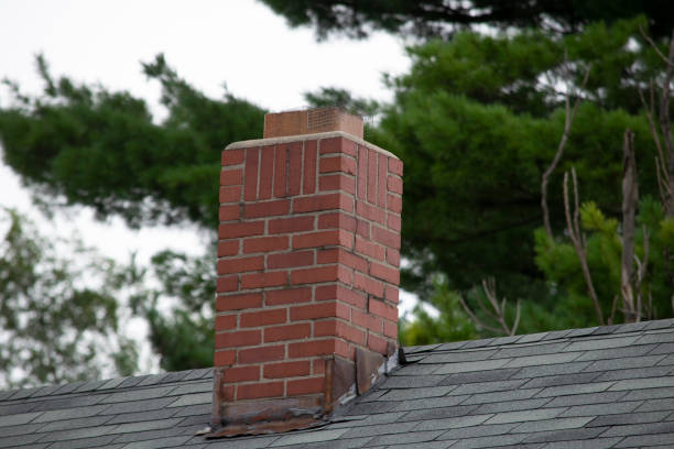 Damaged and old roofing shingles and gutter system on a house Damage to asphalt and asbestos shingles, gutter systems, chimney and roof flashing on residential home chimney stock pictures, royalty-free photos & images