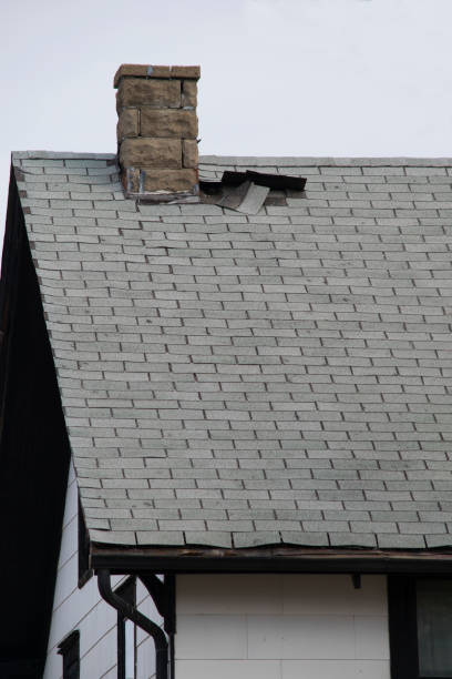 Damaged and old roofing shingles on a house stock photo
