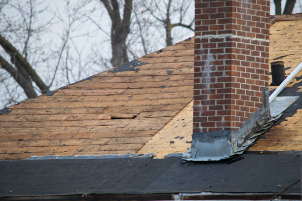 Damaged and old roofing shingles on a house stock photo
