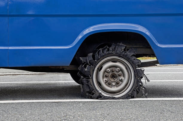 Damaged car tire after tire explosion at high speed. Tyre explosion. Flat van tire. stock photo