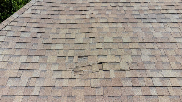 damaged roof shingles stock photo