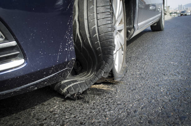 damaged tire after tire explosion at high speed on highway stock photo