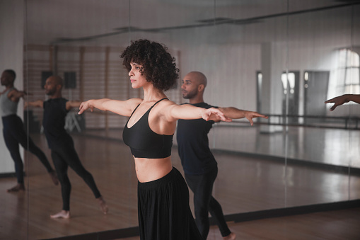 African-american female dance teacher with group of students dance rehearsal in studio
