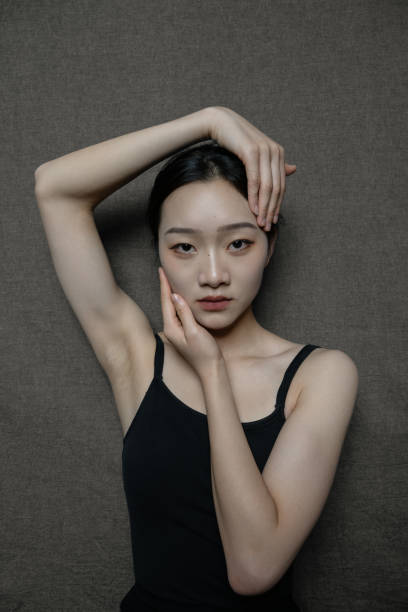 A dancer dressed in black cradled her head in her hands stock photo