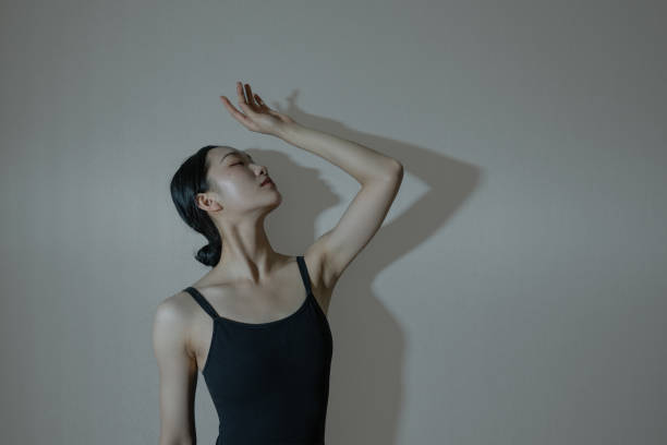 A dancer dressed in black practices her dance moves stock photo