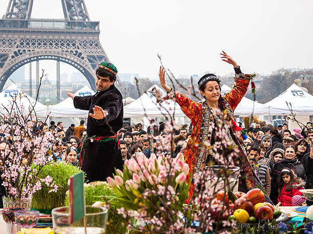 Dancers in traditional persian costume and Eiffel tower. Nowruz. stock photo