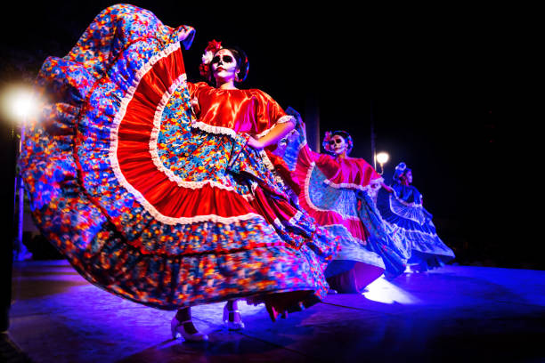 Dancing Catrinas with skull make up for dias de los muertos with traditional dresses at Remate de Paseo Montejo, Merida, Yucatan, Mexico stock photo