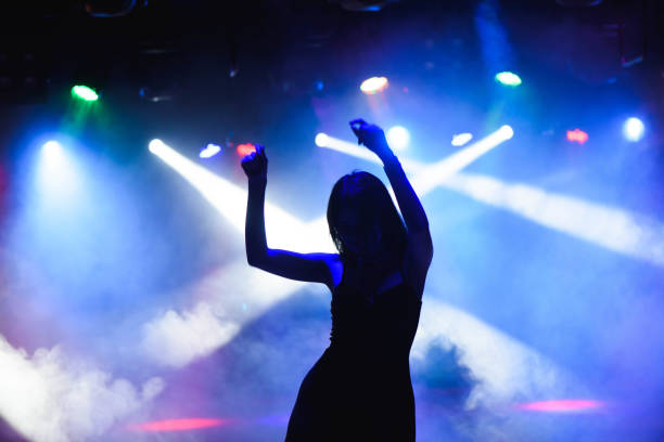 Dancing silhouette of girl in a nightclub. stock photo