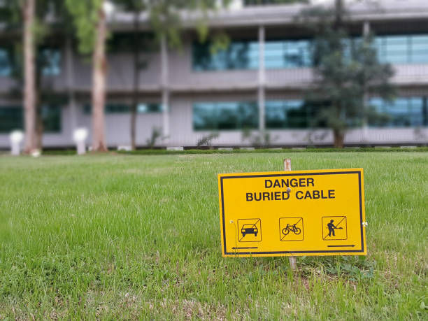 danger buried high voltage cable under the lawn danger buried high voltage cable under the lawn buried stock pictures, royalty-free photos & images