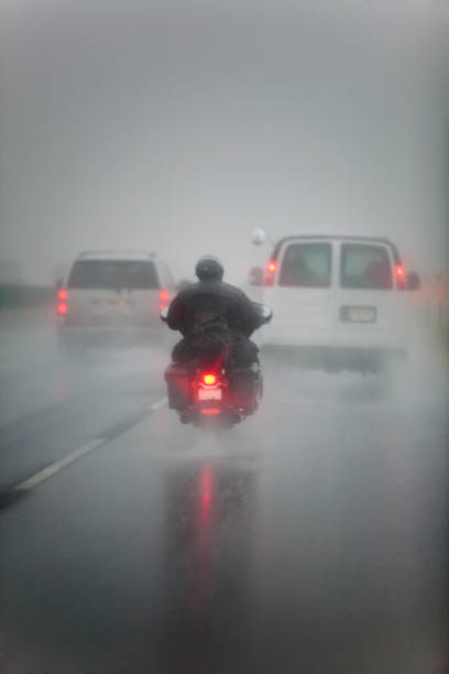 Dangerous wet Driving conditions for motorcycle stock photo