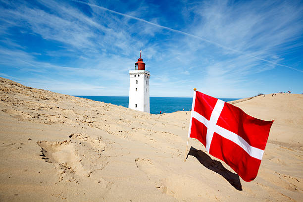 Danish flag and Rubjerg Knude lighthouse stock photo