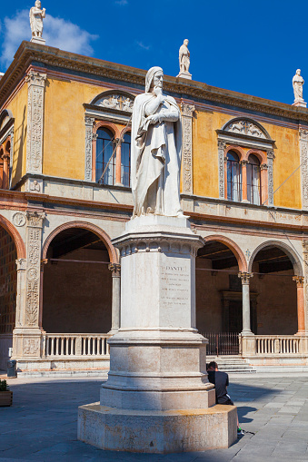 Verona, Italy - September 8, 2016: View on Dante Alighieri monument at the center of Piazza dei Signori.