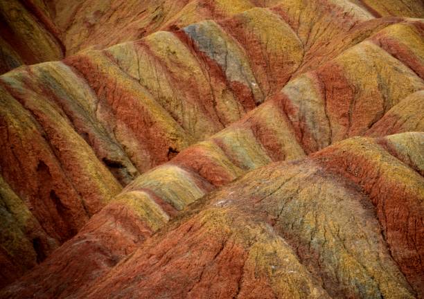Danxia landform geological park, Zhangye, Gansu, China Close-up at the first viewing platform at the Danxia landform geological park near the town of Zhangye. Known for its colorful rock formations, Zhangye Danxia has unusual colours of the rocks, which are smooth, sharp and in layers. They are the result of deposits of sandstone and other minerals that occurred over 24 million years. Gansu province, China danxia landform stock pictures, royalty-free photos & images