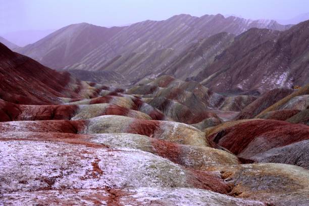 Danxia landform geological park, Zhangye, Gansu, China Stunning Danxia landform geological park near the town of Zhangye. Known for its colorful rock formations, Zhangye Danxia has unusual colours of the rocks, which are smooth, sharp and in layers. They are the result of deposits of sandstone and other minerals that occurred over 24 million years. Gansu province, China danxia landform stock pictures, royalty-free photos & images