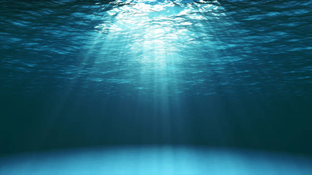 Dark blue ocean surface seen from underwater stock photo