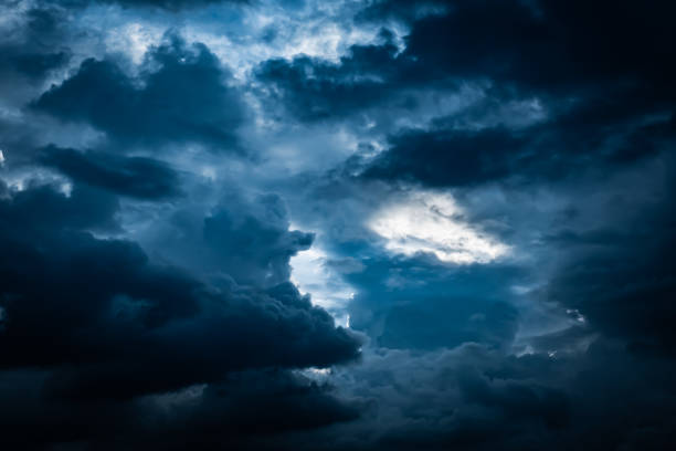 Dark blue storm cloudy sky background stock photo