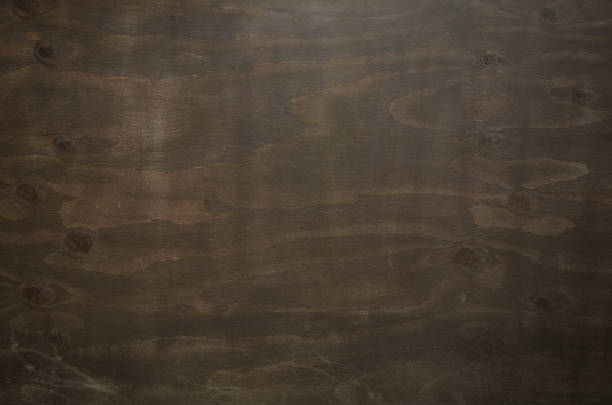 Dark chocolate colored grunge plywood texture background. Close-up of wood texture. stock photo