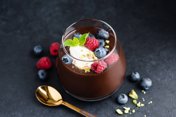 Dark chocolate mousse with berries and cream stock photo