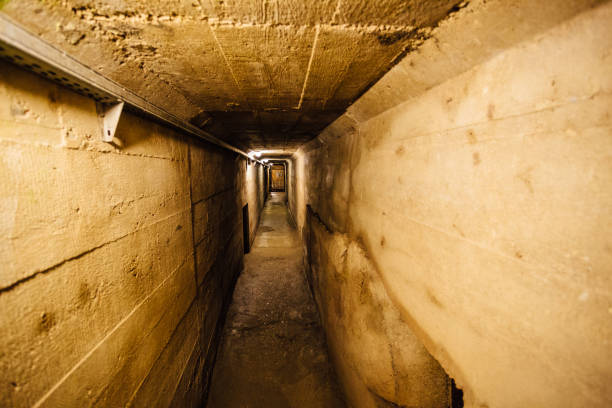 Dark creepy old corridor of underground bunker or prison Dark creepy old corridor of underground bunker or prison. bomb shelter stock pictures, royalty-free photos & images