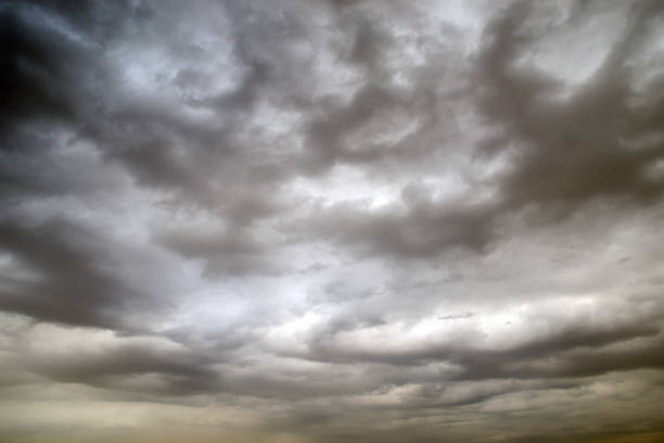 dark gray clouds dark gray clouds backgrounds altostratus stock pictures, royalty-free photos & images