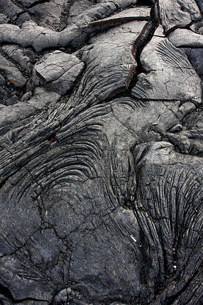 Dark gray rock formation formed by lava stock photo