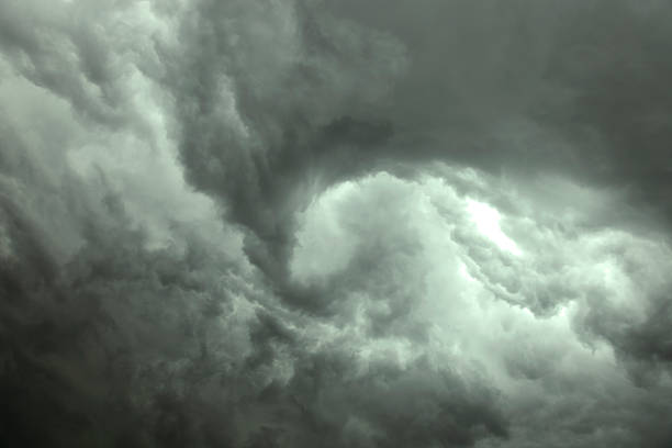 Dark gray swirling storm clouds stock photo