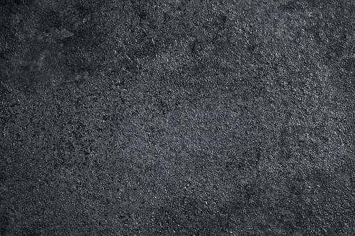 Dark metal surface as a grunge texture for design. Industrial minimalistic background