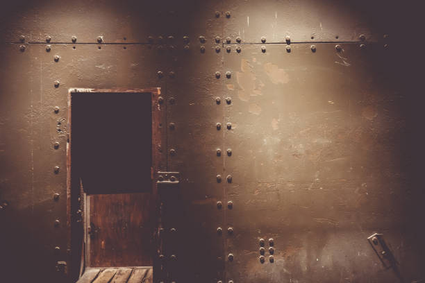 Dark metal wall and door in a bunker Dark metal wall and door in a war bunker bomb shelter stock pictures, royalty-free photos & images