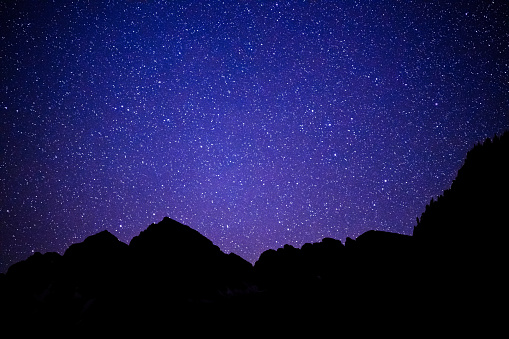 Dark Night and Stars Reflecting in Maroon Lake - Maroon Bells, Aspen Colorado USA.