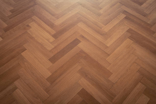 dark parquet floor, wooden floor - parquet flooring herringbone stock photo