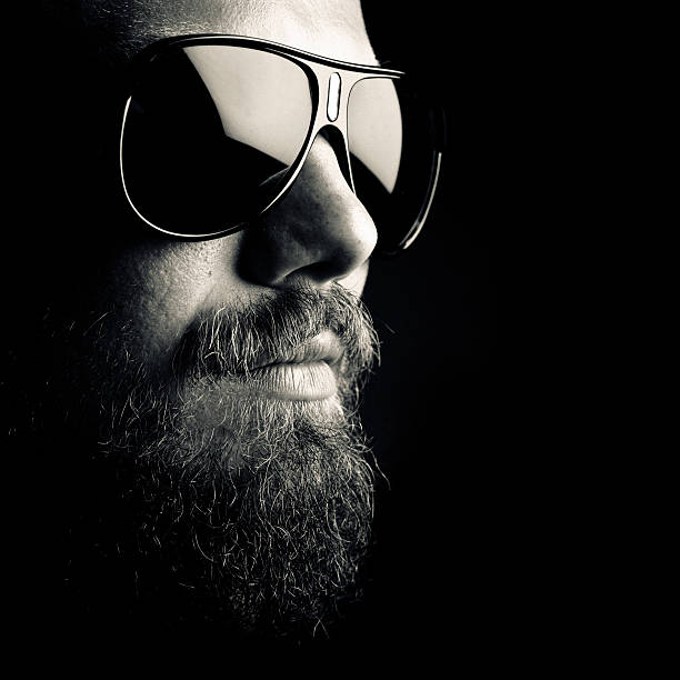 dark portrait bearded man with sunglasses. chiaroscuro stock pictures, royalty-free photos & images