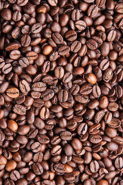 Dark roasted coffee beans texture stock photo