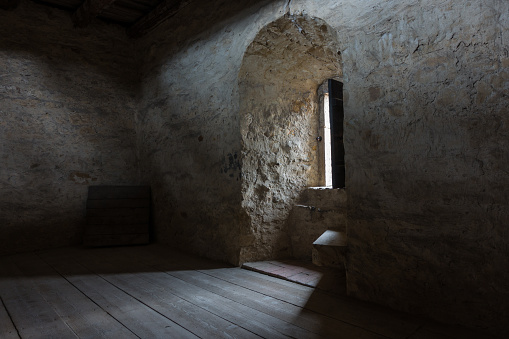Dark room with stone walls and window