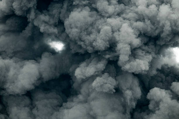 Dark Smoke Dark smoke generated by Volcano eruption. Looking straight up. ash stock pictures, royalty-free photos & images