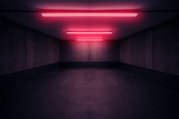 dark underground room with red neon light in basement or parking lot - dark underground room with red neon light in basement or parking lot - fluorescent light photos stock pictures, royalty-free photos & images