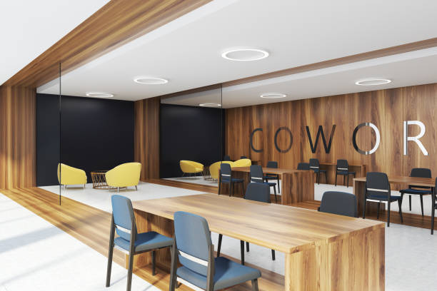 Dark wooden coworking corner Coworking corner with dark wooden and black walls, concrete and wooden floor, tables with black and yellow chairs. 3d rendering mock up coworking stock pictures, royalty-free photos & images