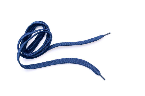 Dark-blue, blue shoelaces isolated on white, crumpled laces, top view stock photo
